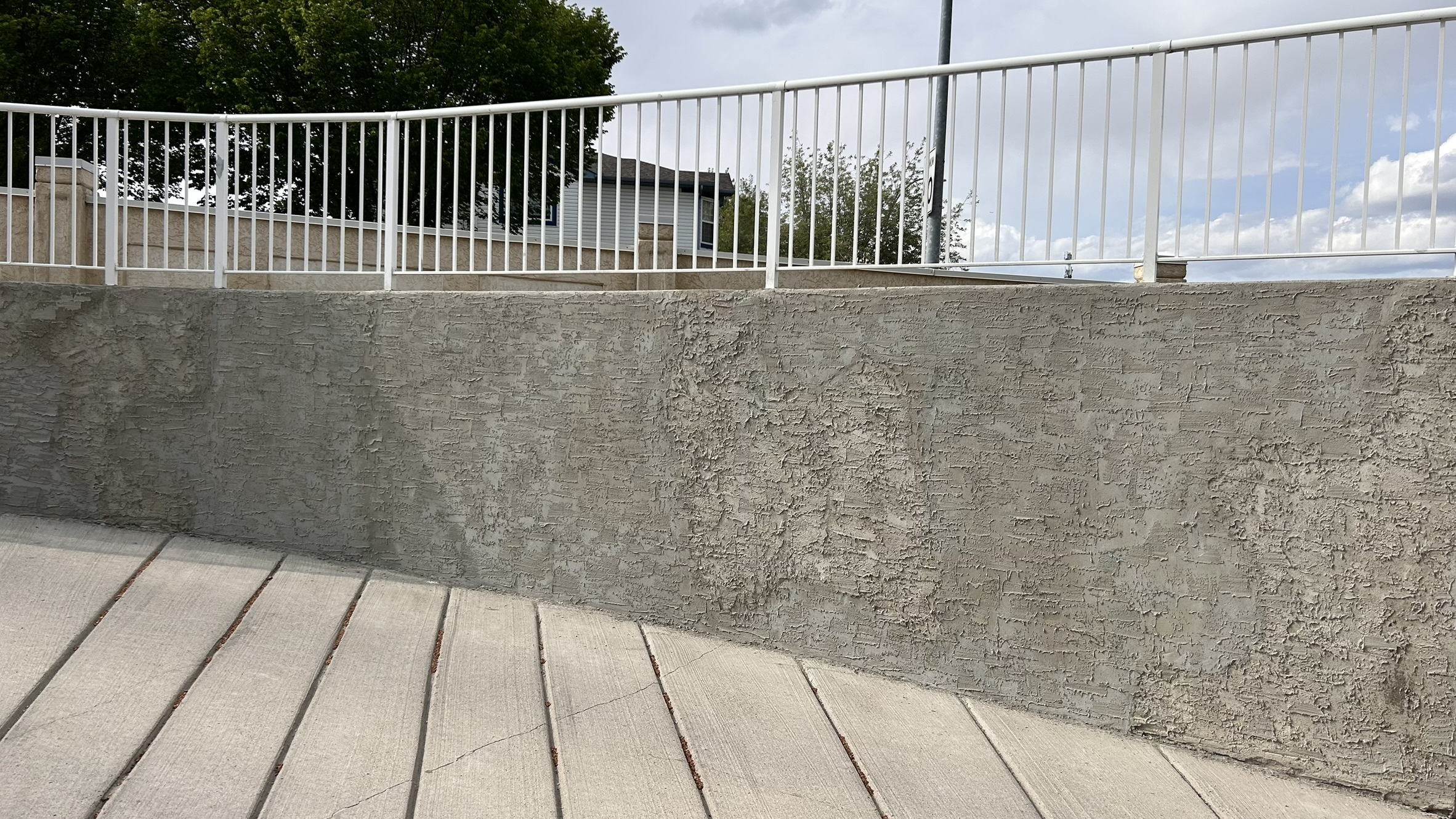 Fresh parging finish on a Calgary retaining wall