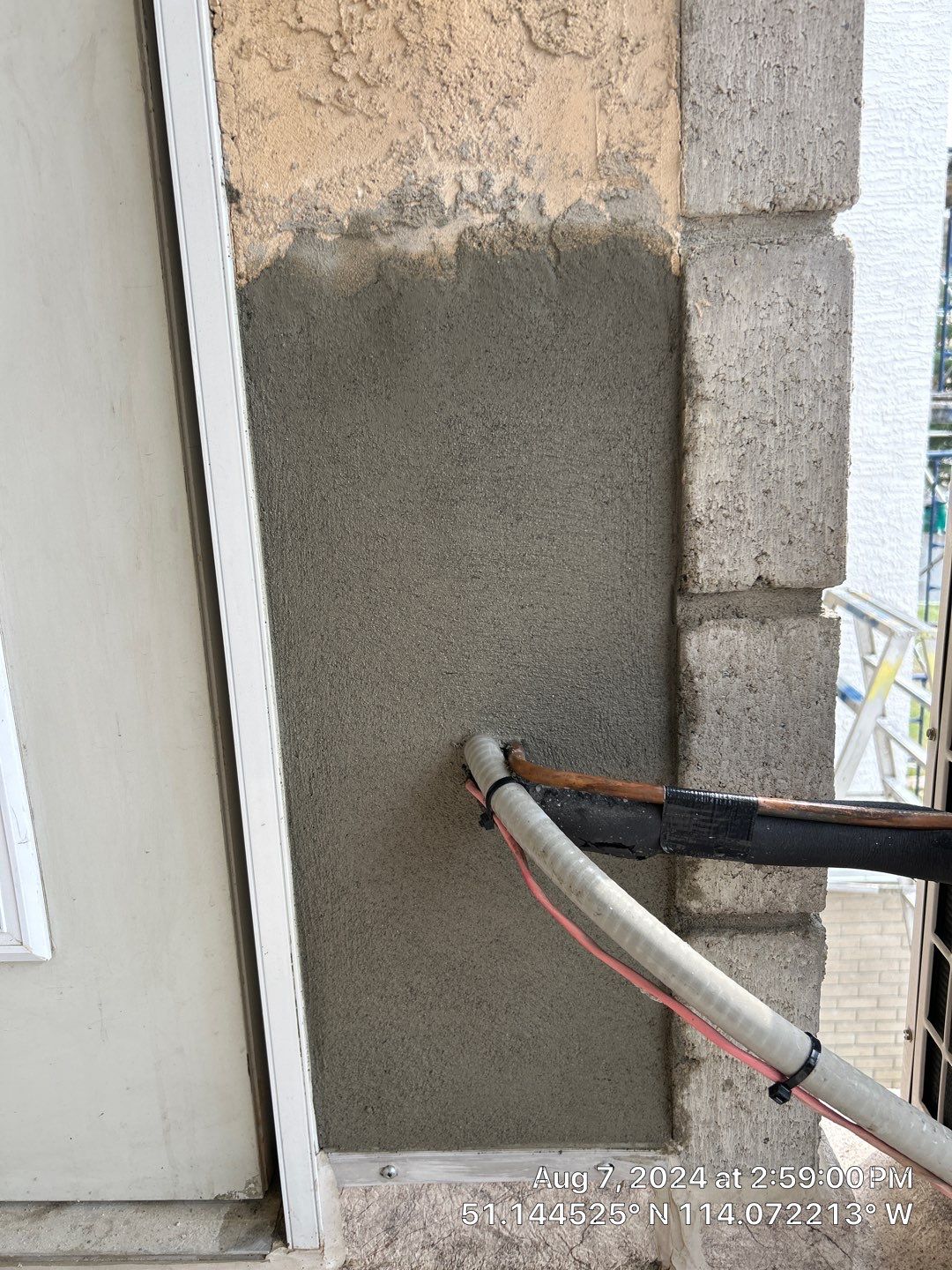 Parging repair project underway on a Calgary exterior