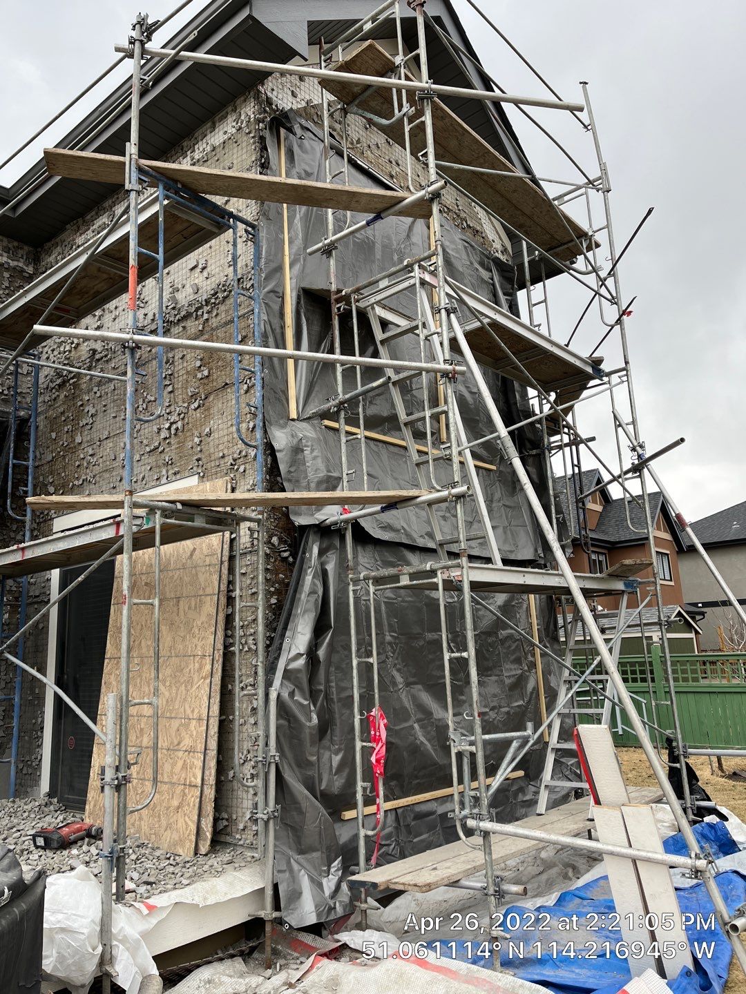 Exterior wall preparation and scaffold setup for Calgary finishing work