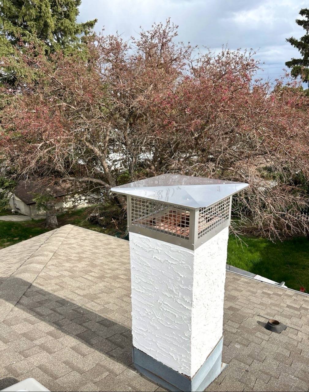 After photo of a Calgary chimney with fresh stucco plaster and a new crown